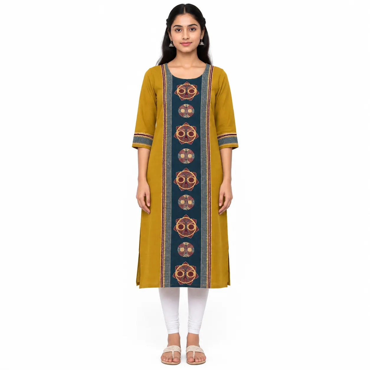 A woman modeling a mustard yellow kurta with a vertical navy blue panel featuring circular patterns, paired with white leggings and beige sandals, against a plain white background.