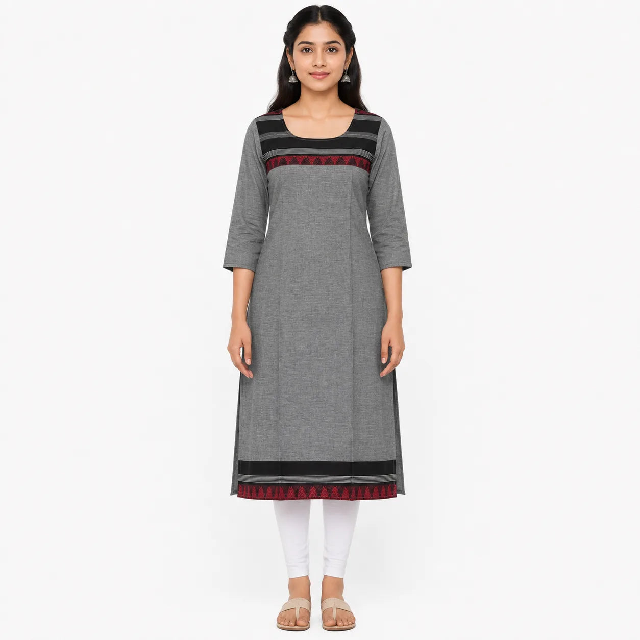 A woman modeling a gray three-quarter sleeve kurta with black and red patterned horizontal bands at the neckline and hem, paired with white leggings and beige sandals, against a plain white background.