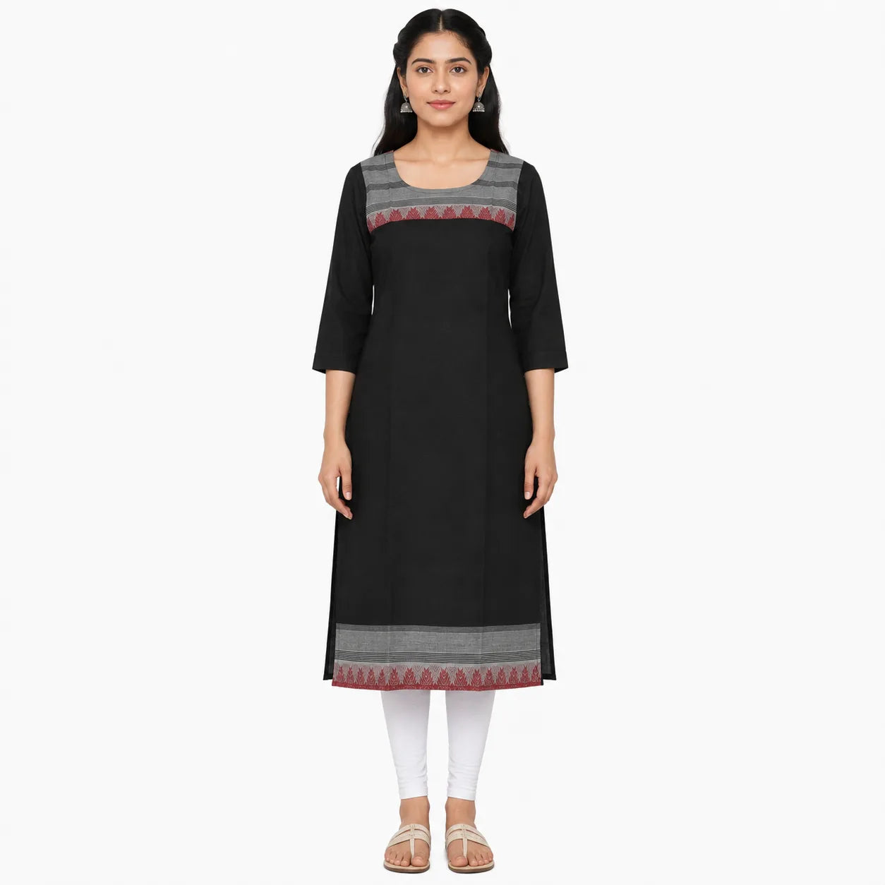A woman modeling a black three-quarter sleeve kurta with gray and red geometric patterned borders on the chest and hem, paired with white leggings and beige sandals, against a plain white background.