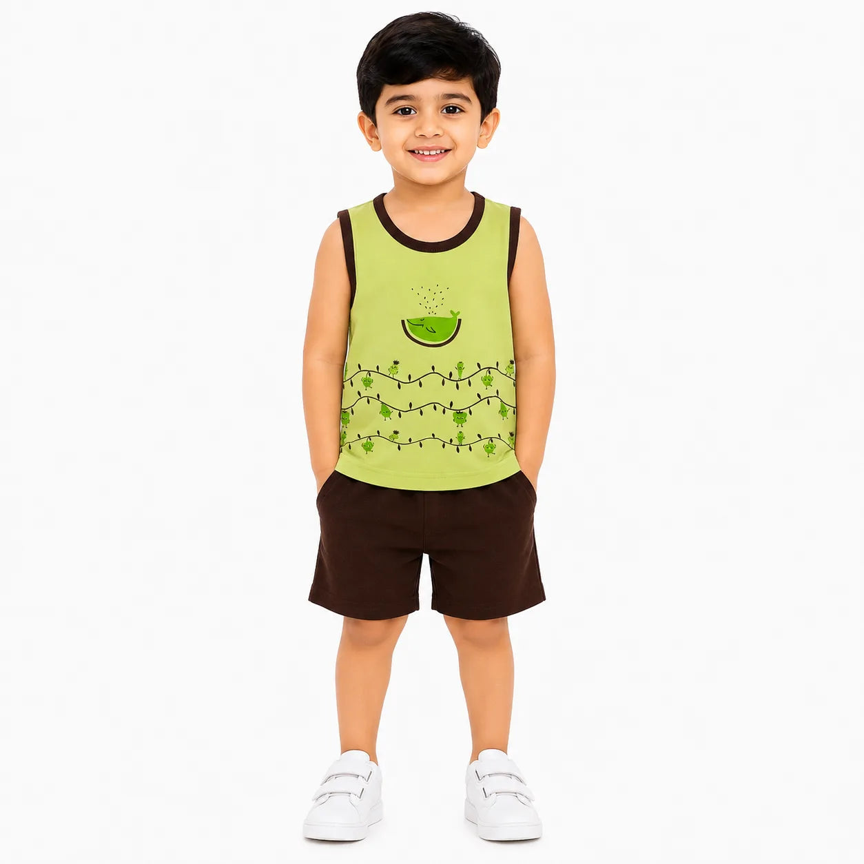 A young boy modeling a sleeveless tank top and shorts set. The tank top is lime green with a watermelon and string art pattern, and the shorts are dark brown.