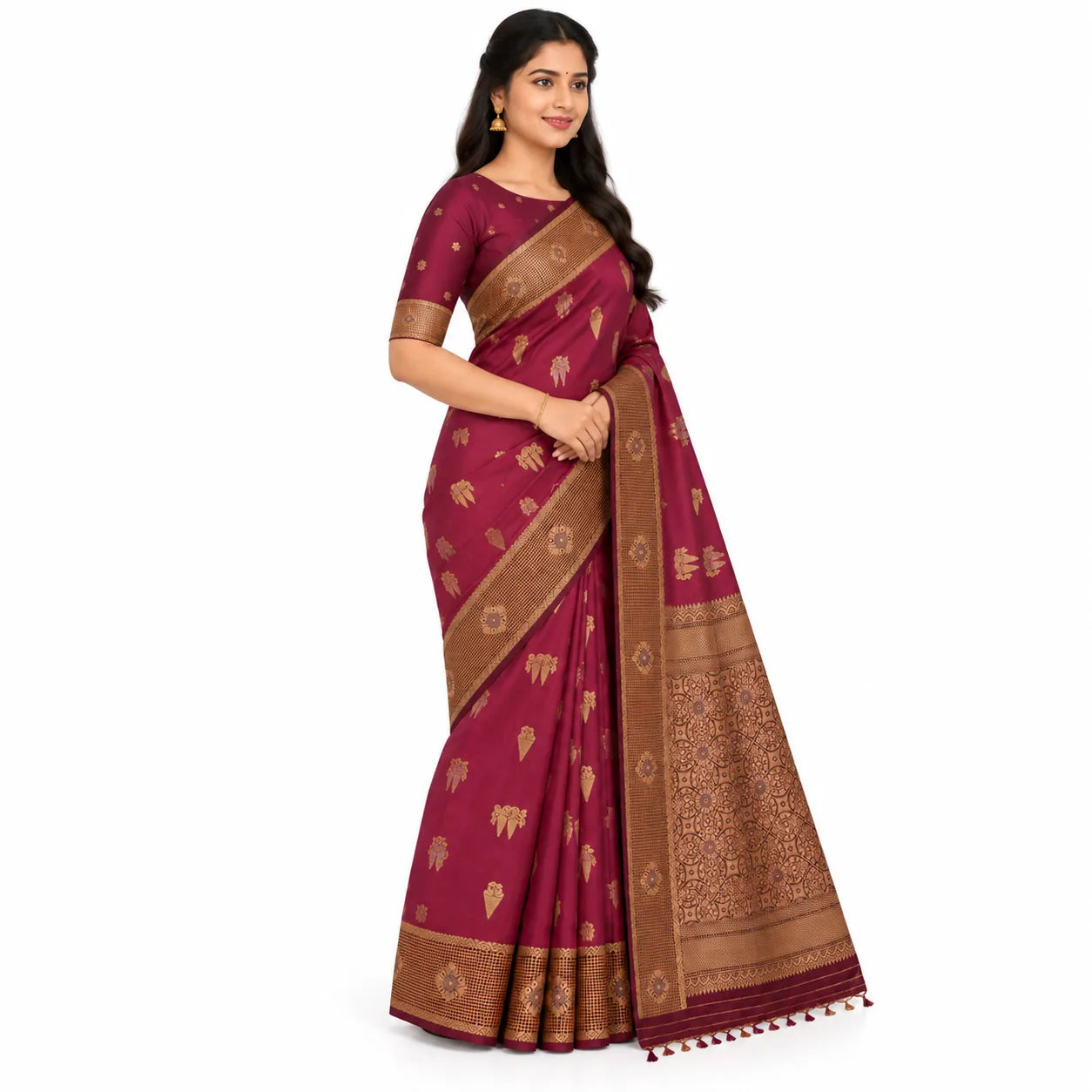 A woman modeling a deep magenta pink saree with gold zari motifs and a wide brown border, set against a plain white background.