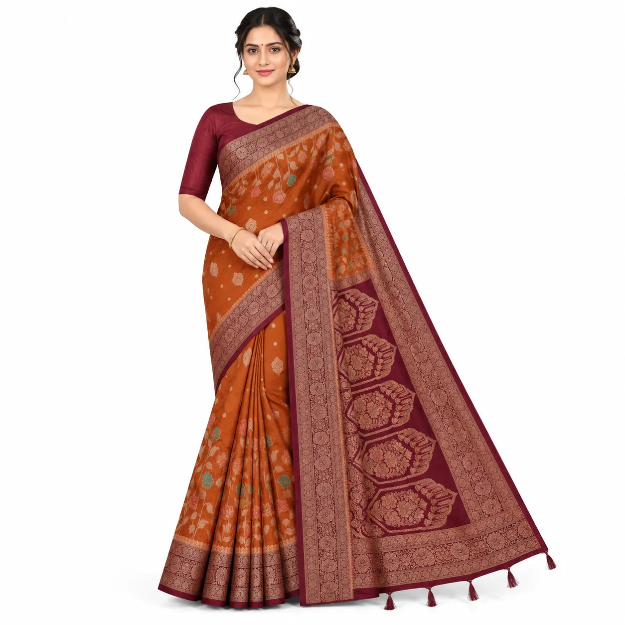 A woman models a traditional Indian saree with a rust-orange body, deep maroon border, and matching maroon blouse against a plain white background.