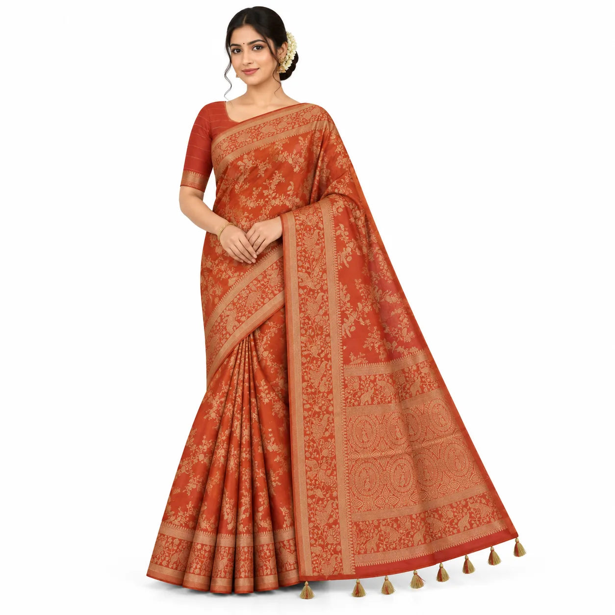 A woman modeling a rust-orange saree with beige floral patterns and a matching blouse, set against a plain white background.