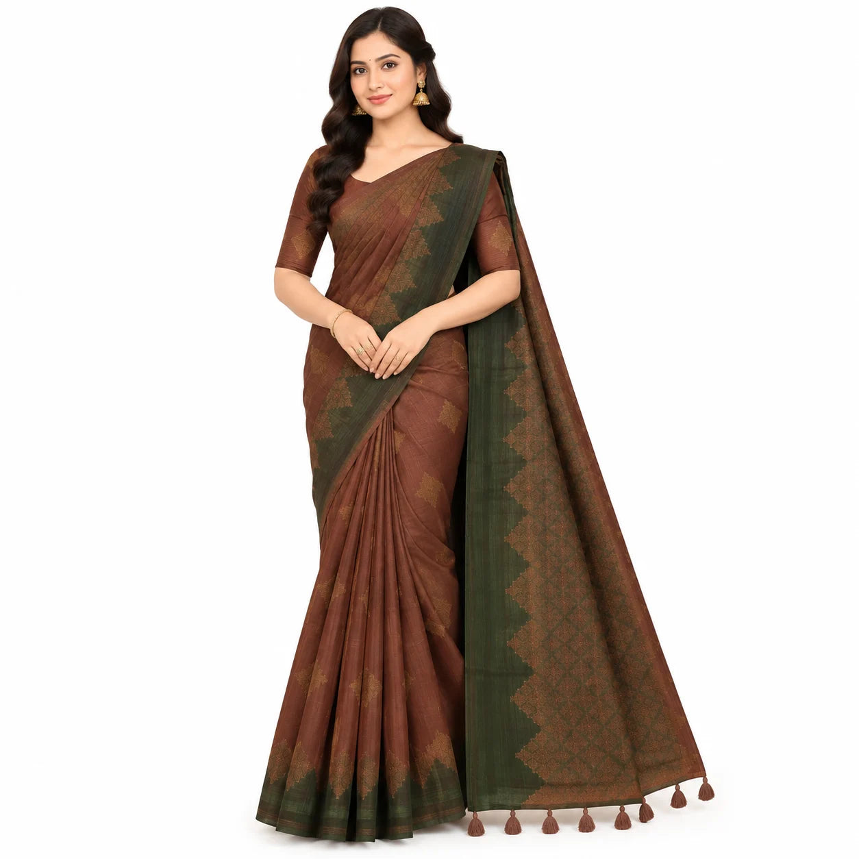 A woman modeling a brown and dark green patterned silk saree with a matching blouse, set against a plain white background.
