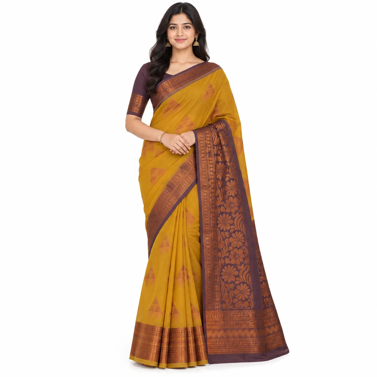 A woman modeling a mustard yellow and dark brown patterned saree with a matching dark brown blouse, set against a plain white background.