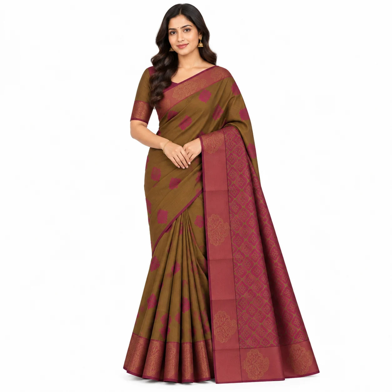 A woman modeling a brown and maroon silk saree with gold zari patterns, standing against a plain white background.