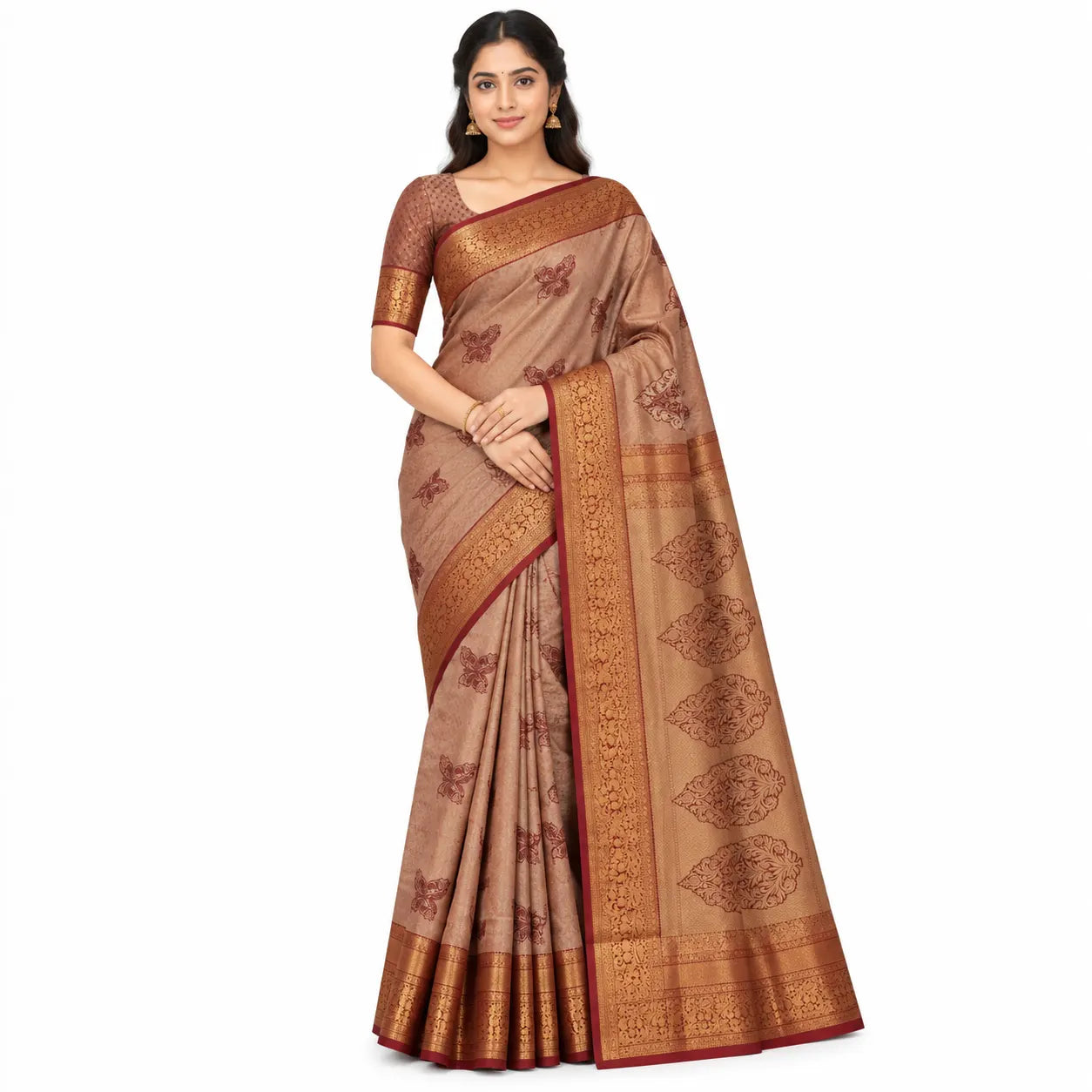 A woman modeling a beige and brown silk saree with gold zari motifs and a deep red border, set against a plain white background.