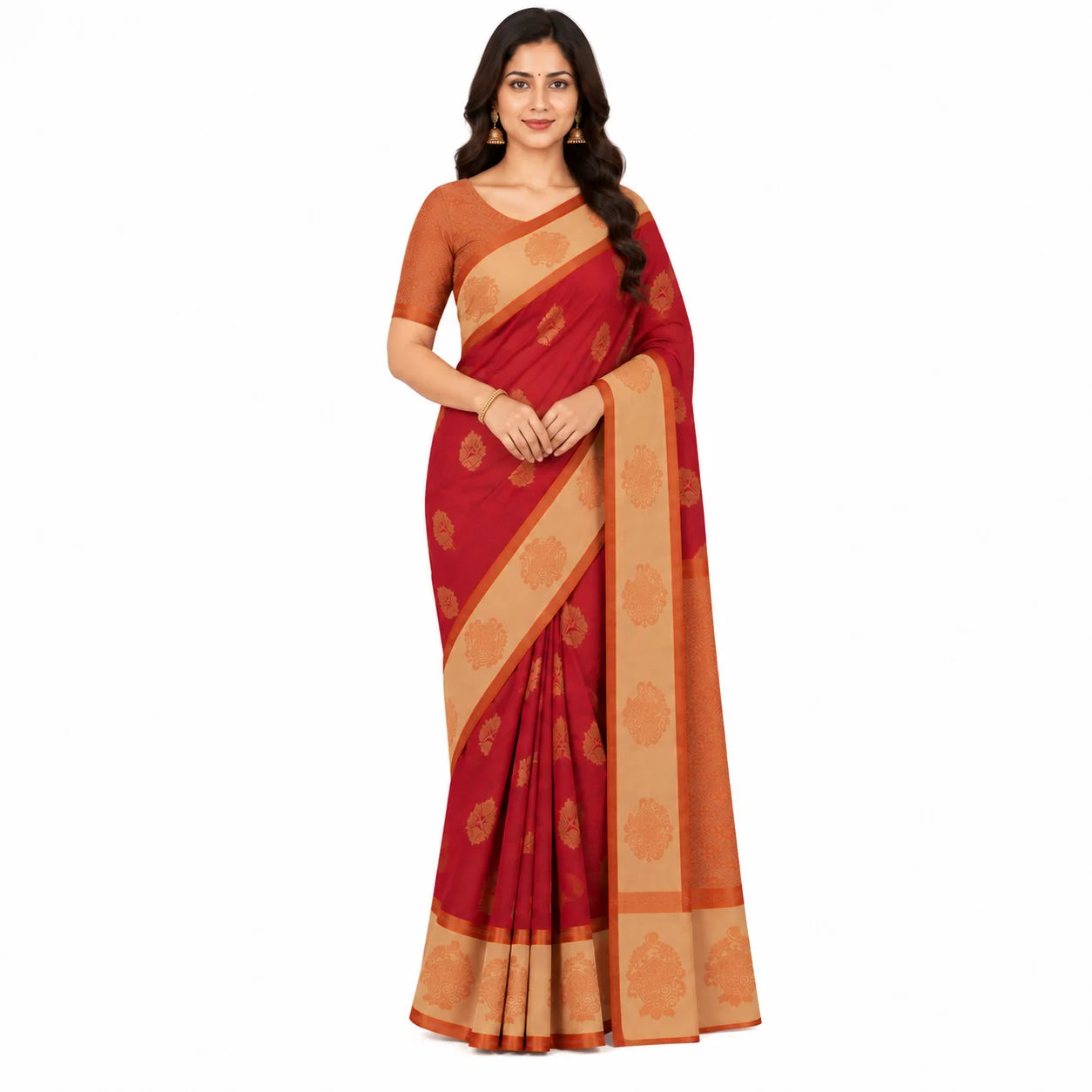 A woman modeling a red and beige saree with traditional patterns, set against a plain white background.