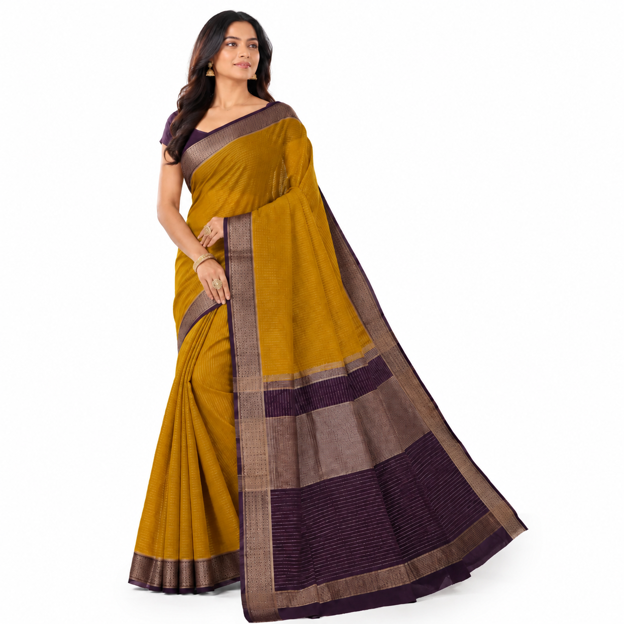 A woman modeling a mustard yellow and dark purple saree with a brown and gold patterned border, set against a plain white background.