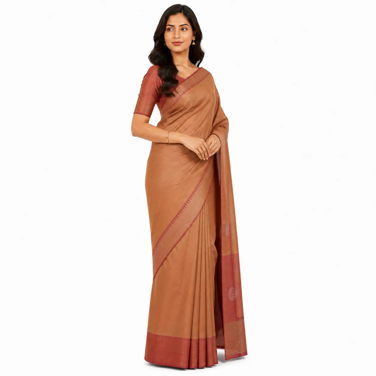 A woman modeling a rust-brown silk saree with a matching short-sleeve blouse against a plain white background.