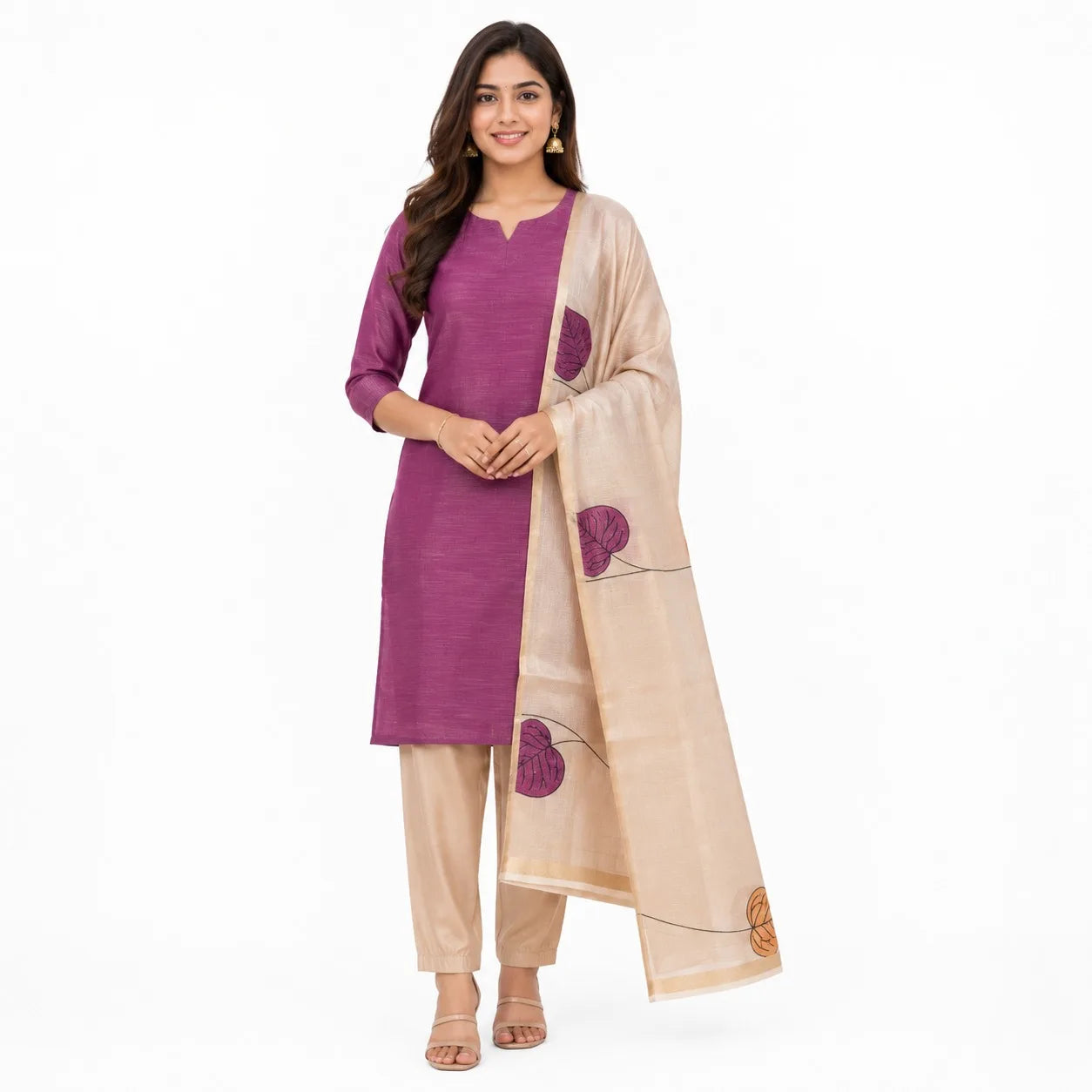A woman modeling a traditional Indian outfit consisting of a purple kurta, beige pants, and a beige dupatta with purple floral motifs, set against a plain white background.