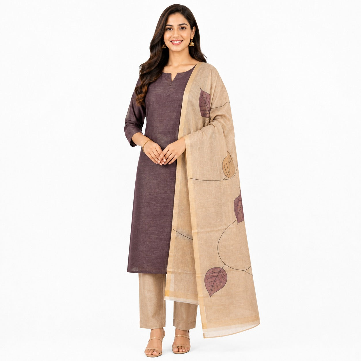 A woman modeling a traditional Indian outfit consisting of a dark plum kurta, beige trousers, and a beige dupatta with leaf patterns, set against a plain white background.