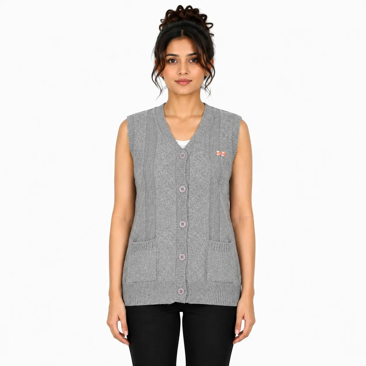 A woman modeling a sleeveless gray knit button-front vest with a small pink embroidered logo on the left chest, paired with black pants against a plain white background.