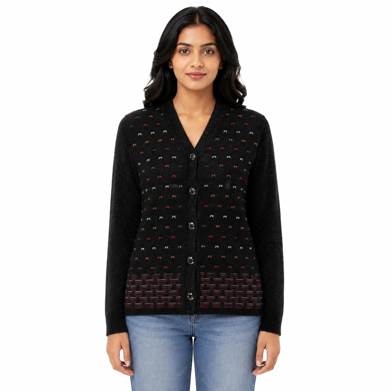 A woman modeling a black knit cardigan sweater with a small repeating red and white pattern and a red-and-black woven-style border near the hem, paired with light blue jeans against a plain white background.