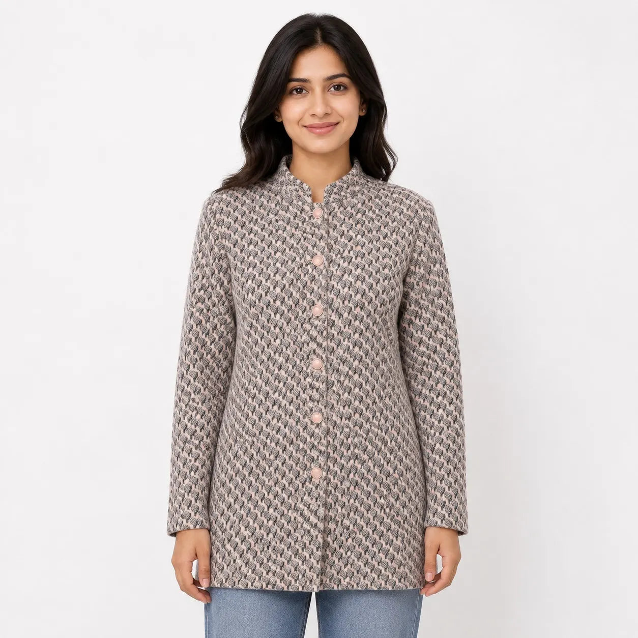 A woman modeling a long-sleeve, mandarin-collar button-up jacket with a textured, woven geometric pattern in beige and brown tones, paired with blue jeans against a plain white background.