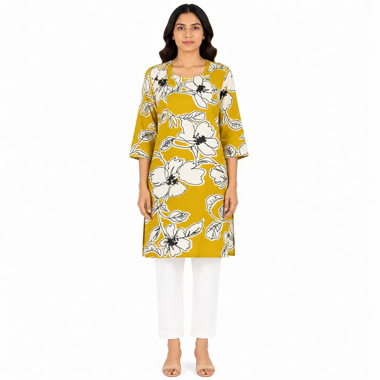 A woman modeling a mustard yellow three-quarter sleeve kurta with a white and black floral print, paired with white cropped pants and beige flat sandals, against a plain white background.
