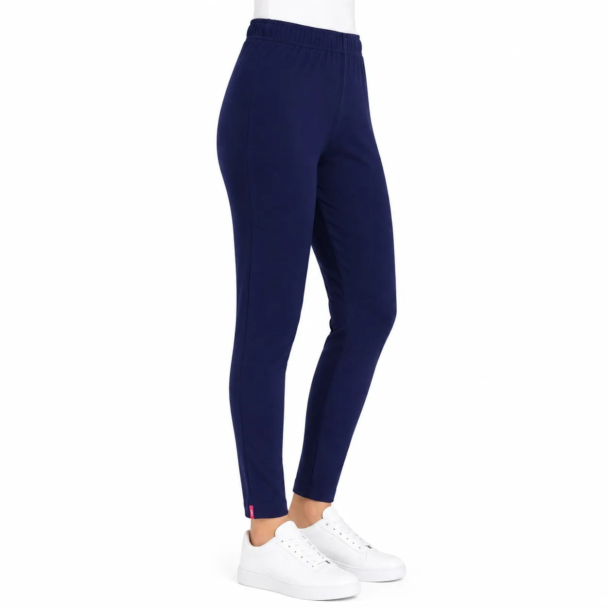 A person wearing navy blue leggings and white sneakers, shown from the waist down against a plain white background.