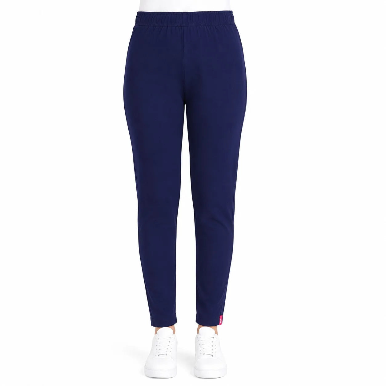 A pair of navy blue jogger pants shown on a model from the waist down, paired with white sneakers against a solid white background.