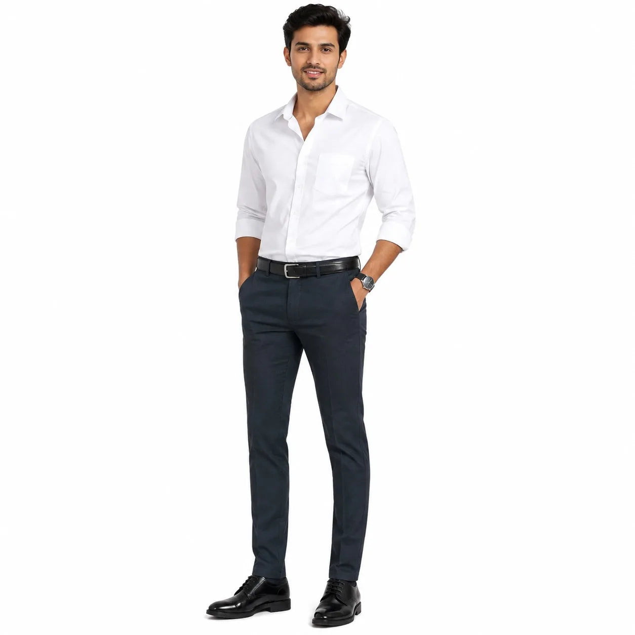 A man modeling a white long-sleeve button-down shirt and dark navy blue trousers, paired with a black belt and black dress shoes, against a plain white background.