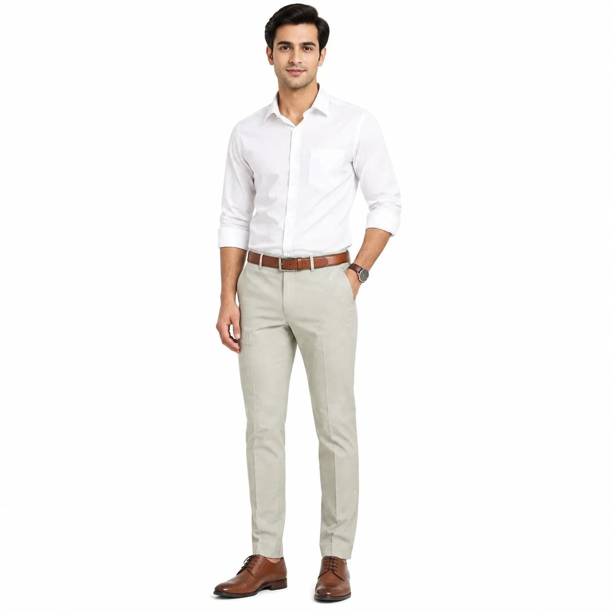 A man modeling a white long-sleeve button-down shirt, light beige trousers, a brown belt, and brown leather dress shoes against a plain white background.