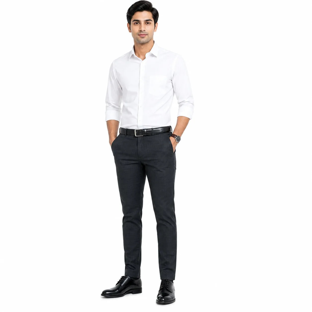 A man modeling a white long-sleeve button-down shirt tucked into dark charcoal gray trousers, paired with a black belt, black dress shoes, and a watch, on a solid white background.