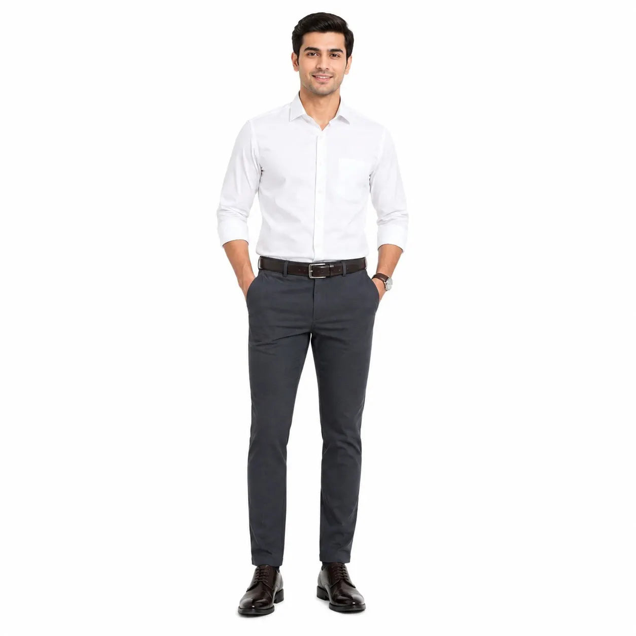 A man modeling a white long-sleeve button-down shirt and dark gray slim-fit trousers with a brown belt and black dress shoes, standing against a plain white background.