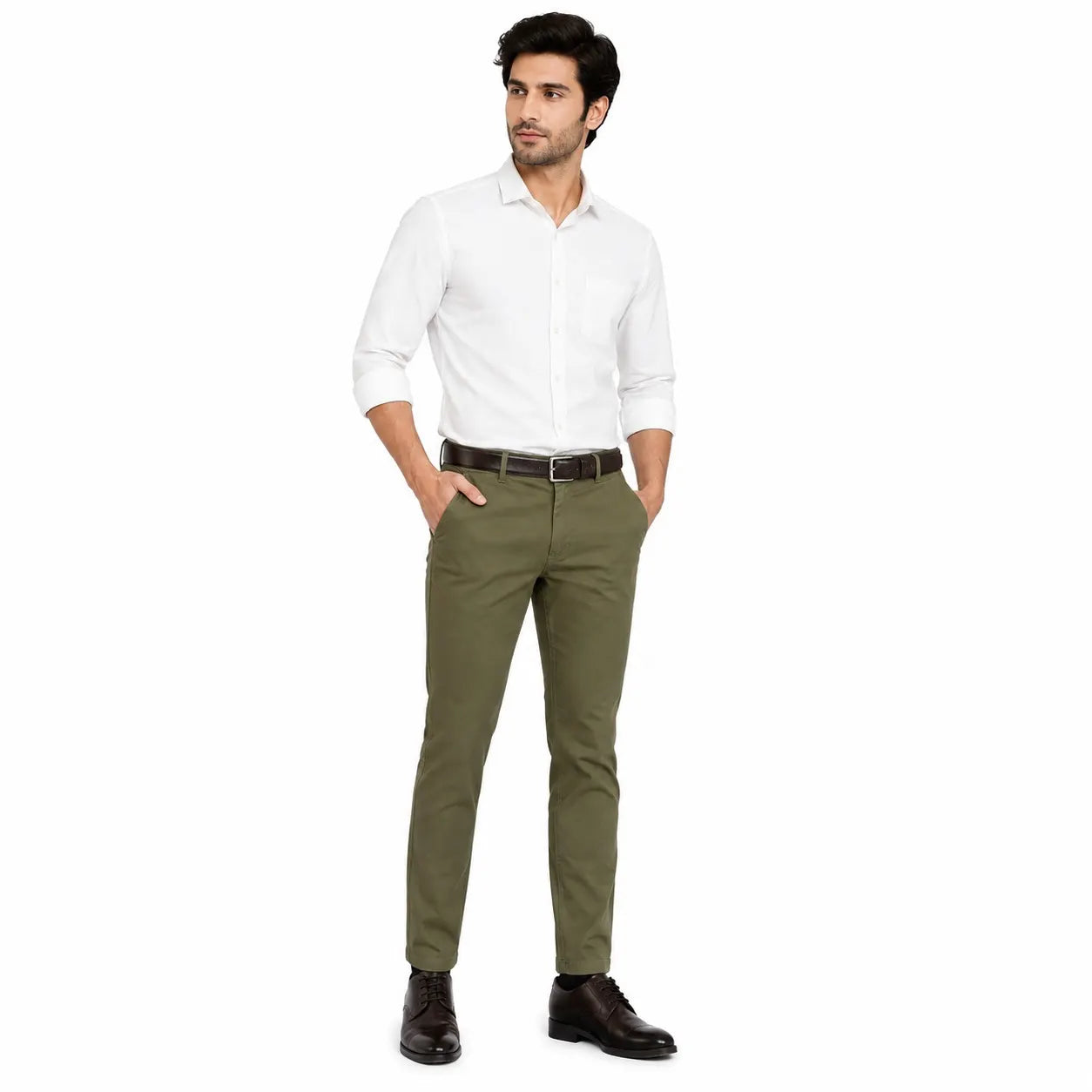 A man modeling a white long-sleeve button-down shirt and olive green slim-fit trousers with a dark brown belt and black leather dress shoes, set against a plain white background.