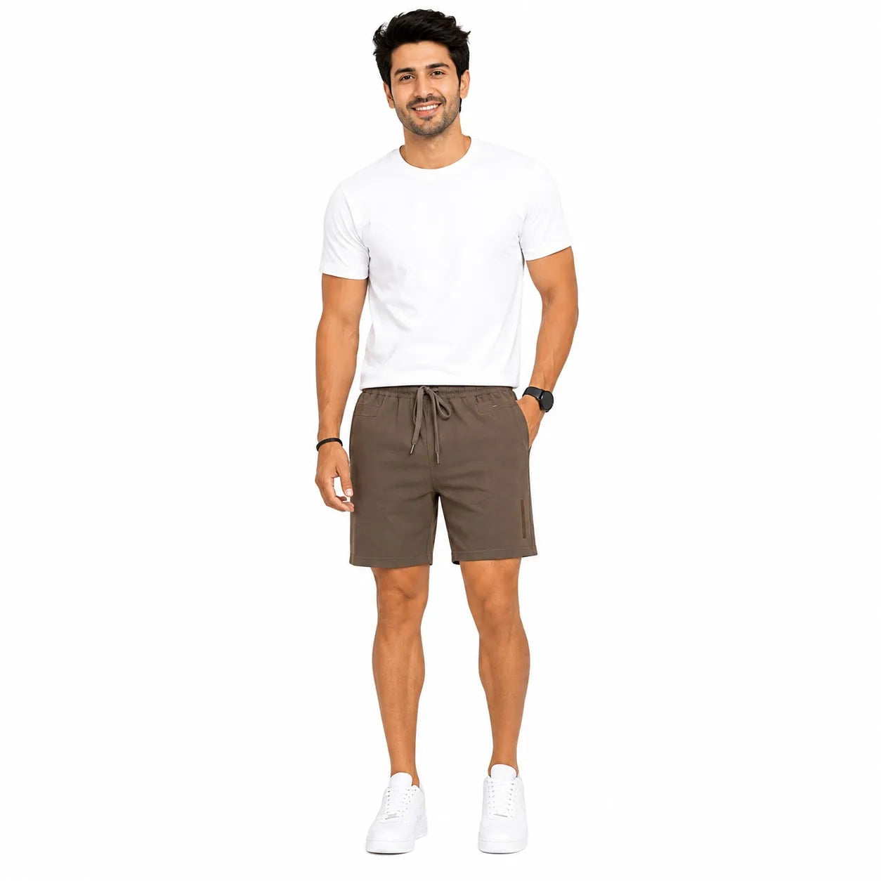 A man modeling a white crewneck t-shirt and brown drawstring shorts against a solid white background.
