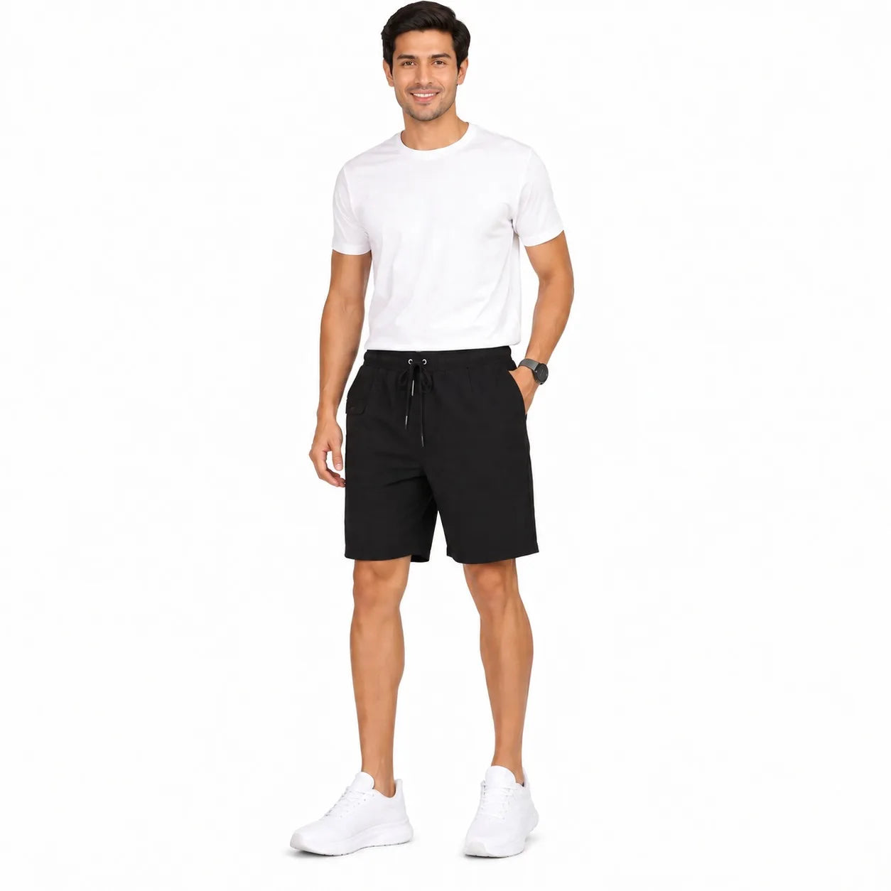 A man modeling black athletic drawstring shorts, paired with a white t-shirt and white sneakers, standing against a solid white background.