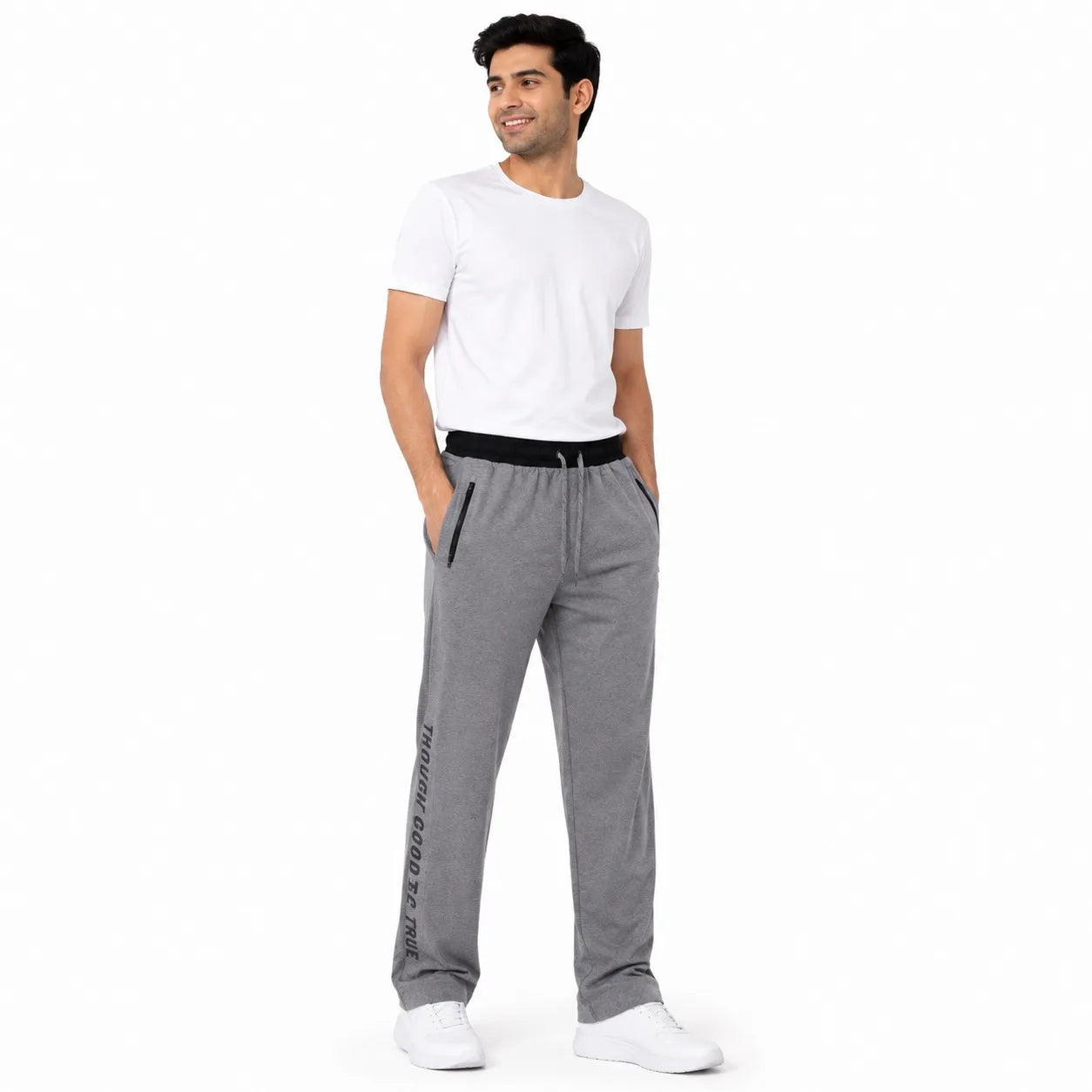 A man modeling gray heather sweatpants with a black waistband and black side details, paired with a white t-shirt and white sneakers, against a plain white background.