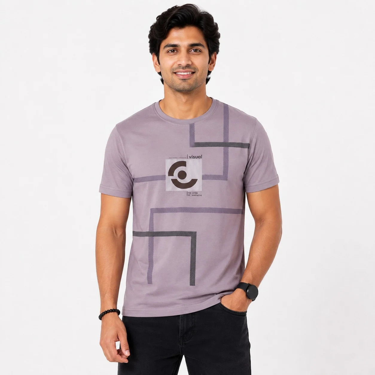 A man wearing a light purple crewneck t-shirt with a dark gray geometric line pattern and a circular graphic on the chest, paired with black pants, against a plain white background.