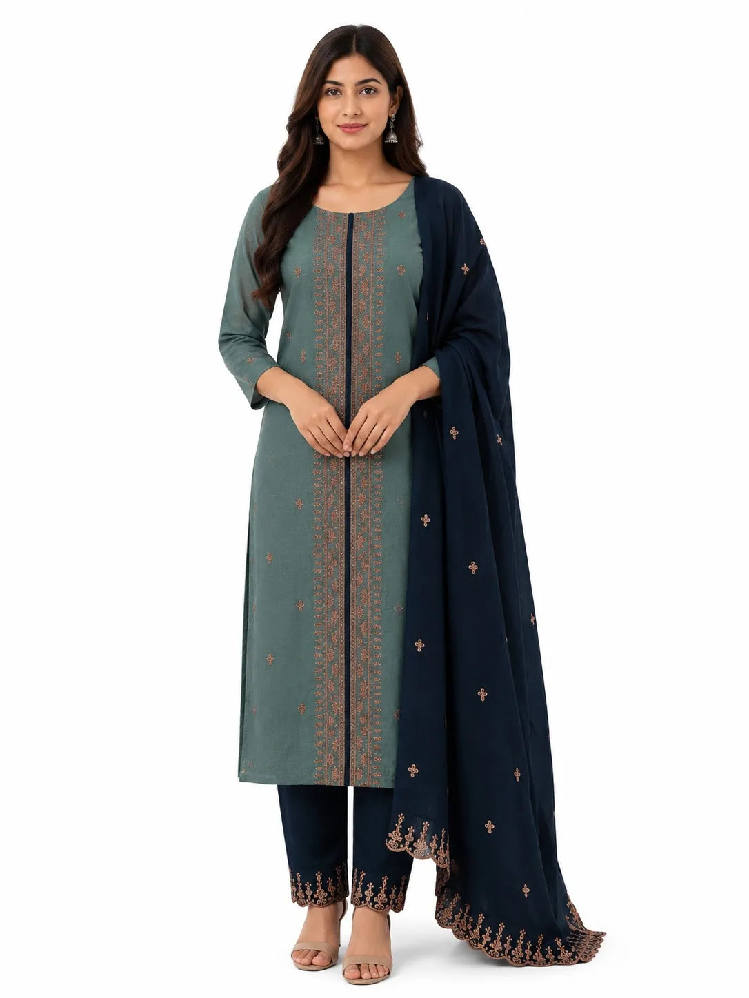 A woman modeling a traditional Indian salwar kameez set featuring a muted sage green kurta with gold embroidery, navy blue pants, and a navy blue dupatta with gold motifs, set against a plain white background.