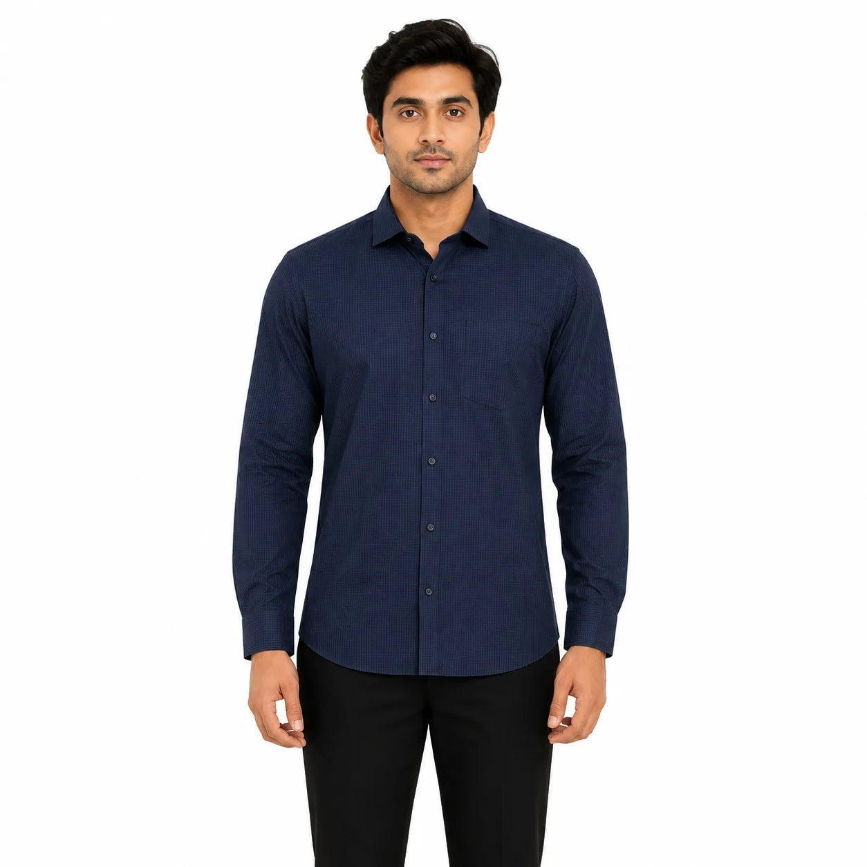 A man wearing a dark navy blue long-sleeve button-down shirt and black trousers, standing against a plain white background.