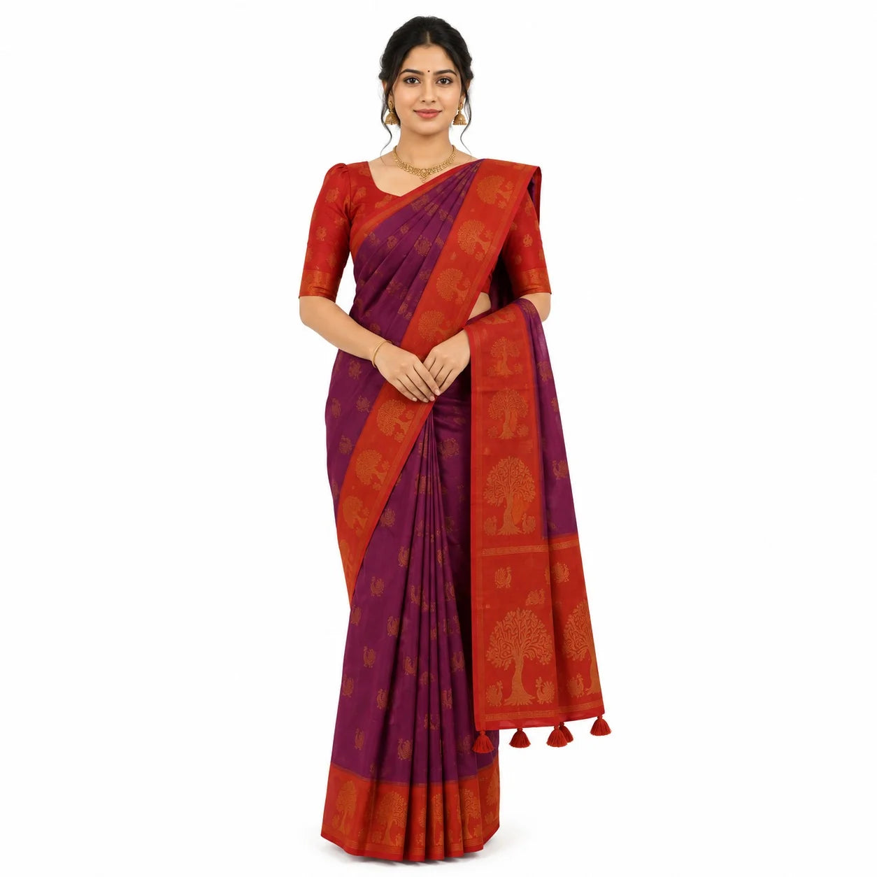 A woman modeling a purple and red silk saree with gold tree motifs, standing against a plain white background.