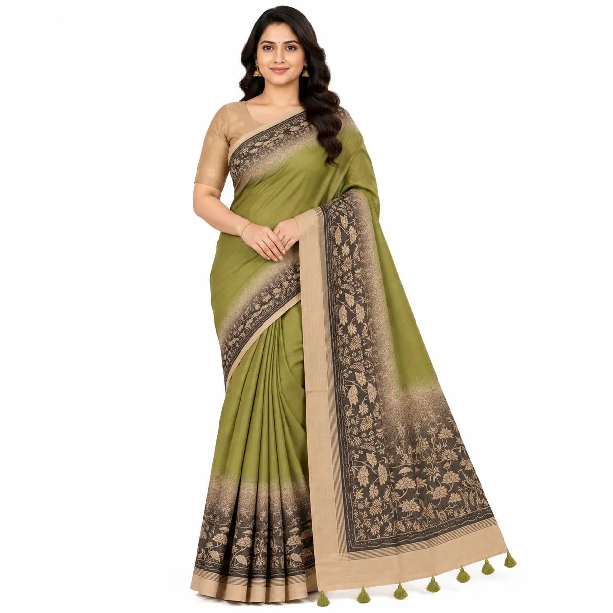 A woman models a sage green saree with a beige and brown floral patterned border and pallu, paired with a beige sleeveless blouse, against a plain white background.